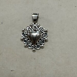 Vintage Taxco Mexico sterling silver heart shaped pendant.